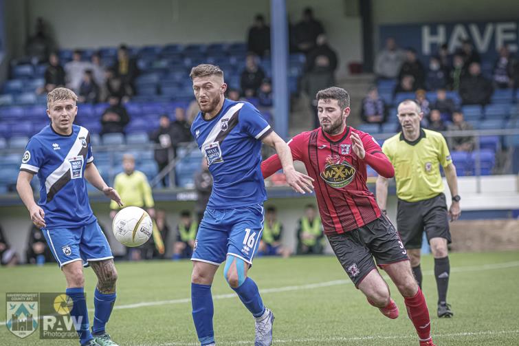 Kurtis Rees and Kieran Lewis fight for possession